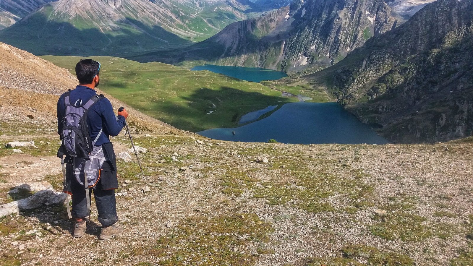 a trekkers looking down at the kishansar lake of kashmir great lakes trek