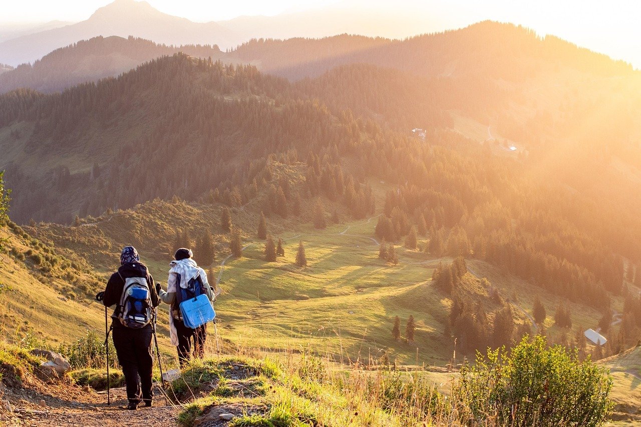 Two hikers walking on the Warwan Valley trek at sunrise