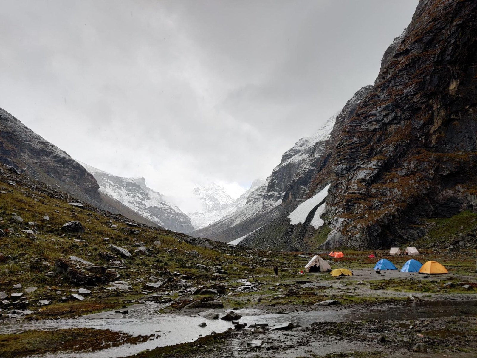 Trekkers are camping at a flat surface between the mountains Trekkers are camping at a flat surface between the mountains