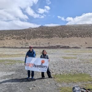 Trekkers holding the banner of cliffhangers on the Markha Valley trek