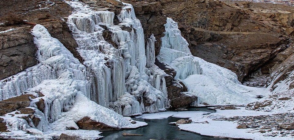 Frozen waterfall in a rocky valley near Manali