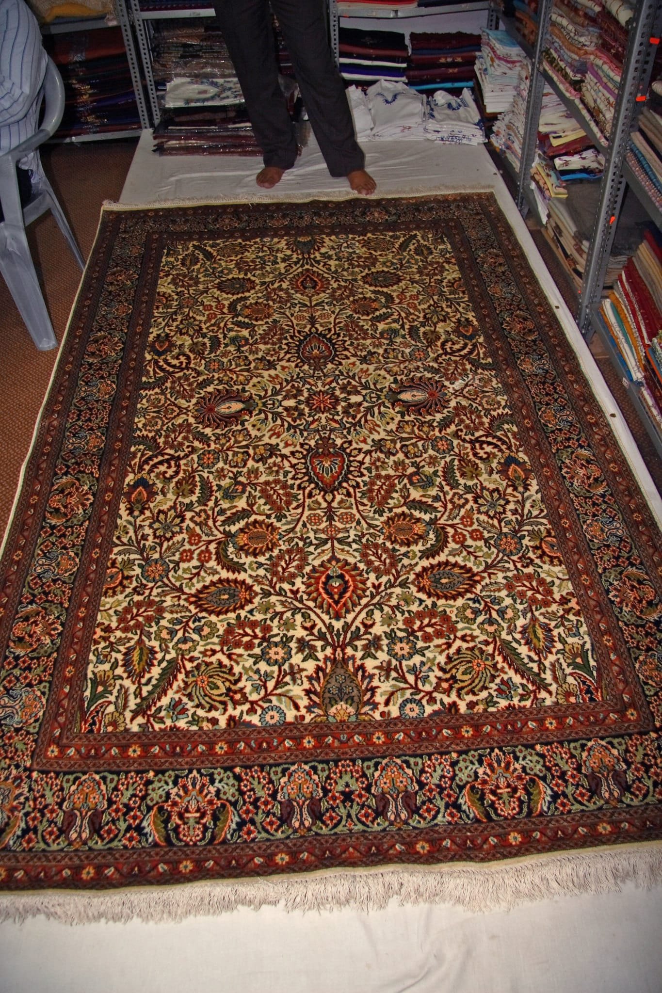 handwoven Kashmiri carpet with detailed floral and paisley patterns in red