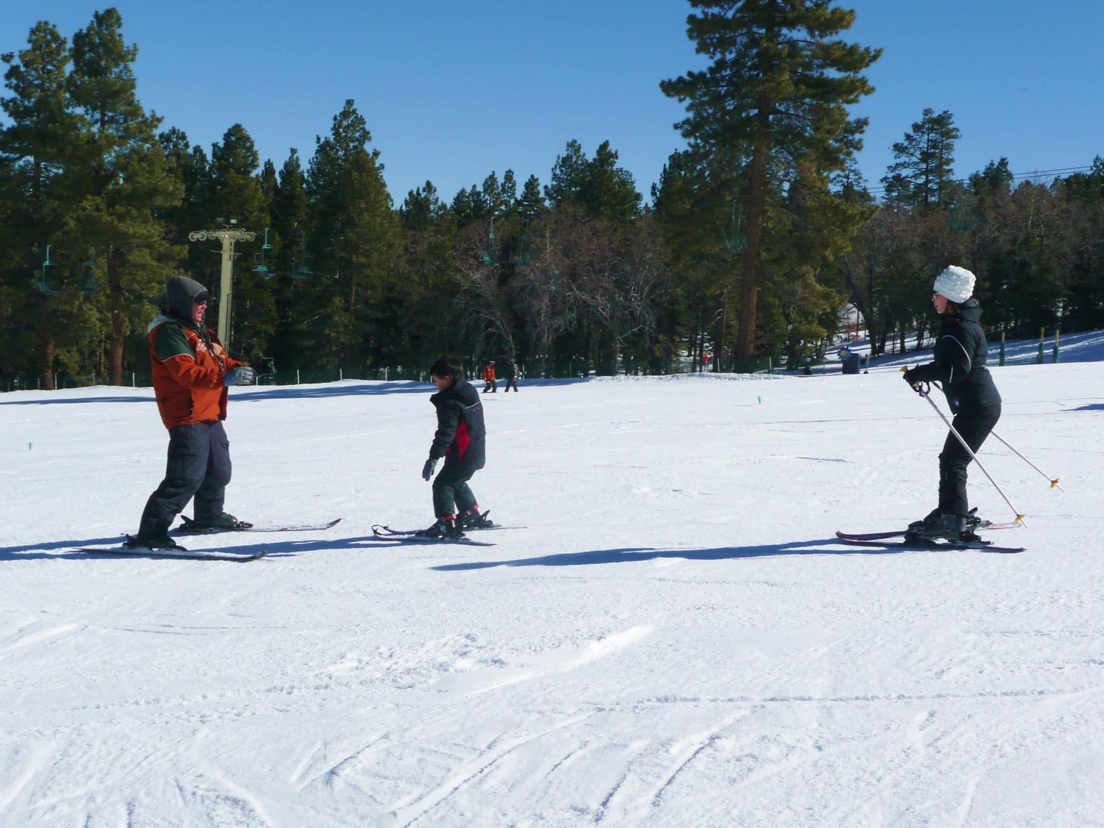 Family skiing on a snowy slope