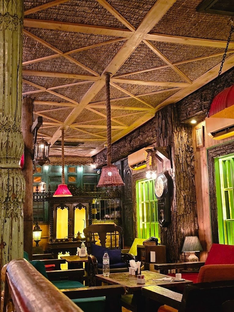Cafe Liberty offers a cozy, rustic vibe with warm lights and vintage decor.