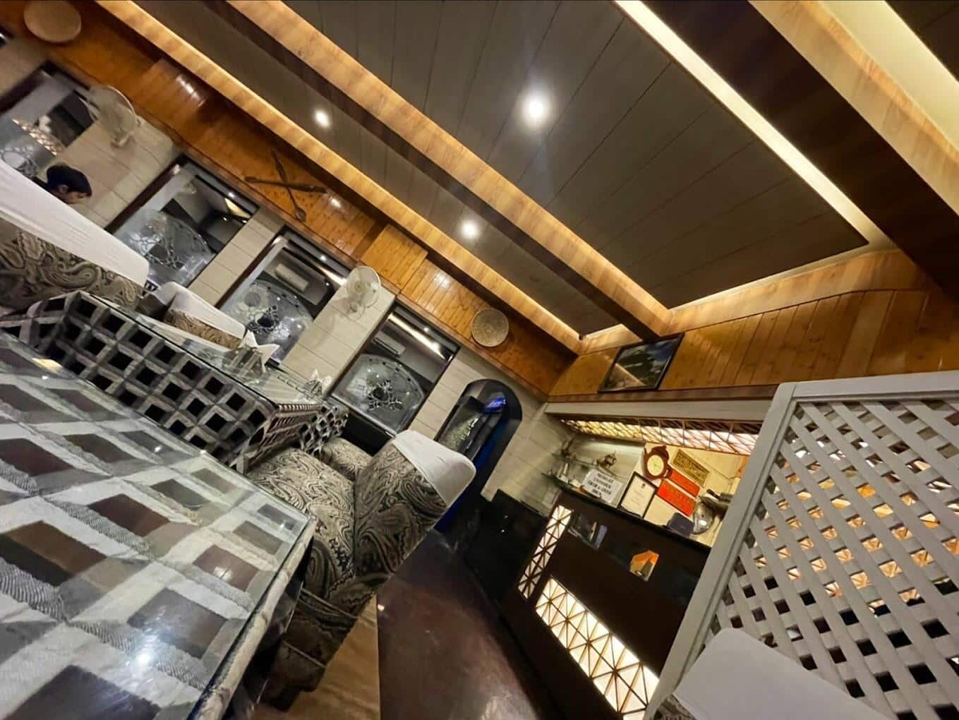 Shamyana Restaurant offers cozy seating with warm, wood-accented interiors in Srinagar