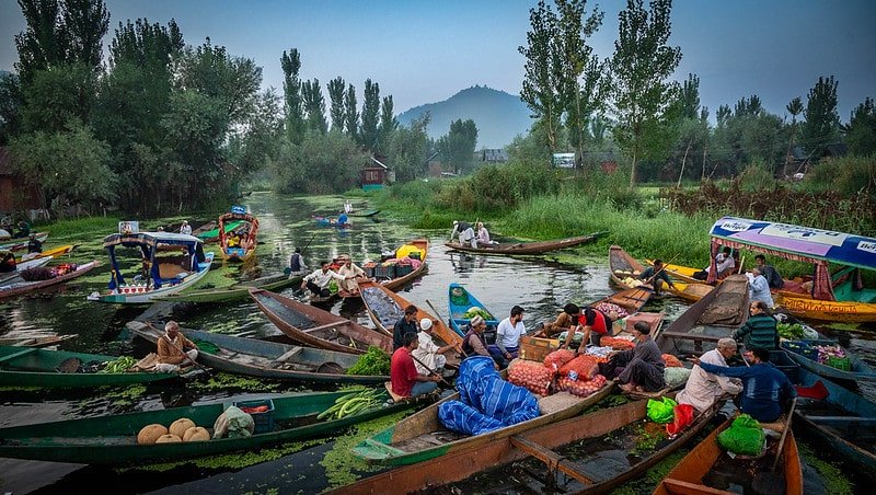 People selling vegetable in shikara in floating market at dal lake