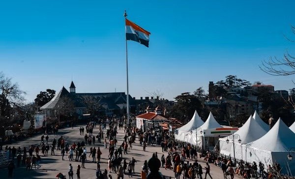 Mall Road in Shimla with people walking and the Indian flag flying high