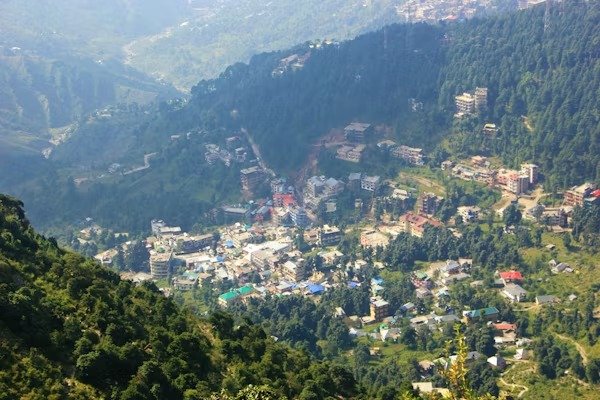 Aerial view of Jakhoo Hill, a small town nestled in green forested hills