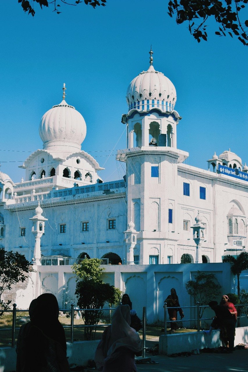Gurudwara Sahib is a white Sikh temple with domes and arches in shimla