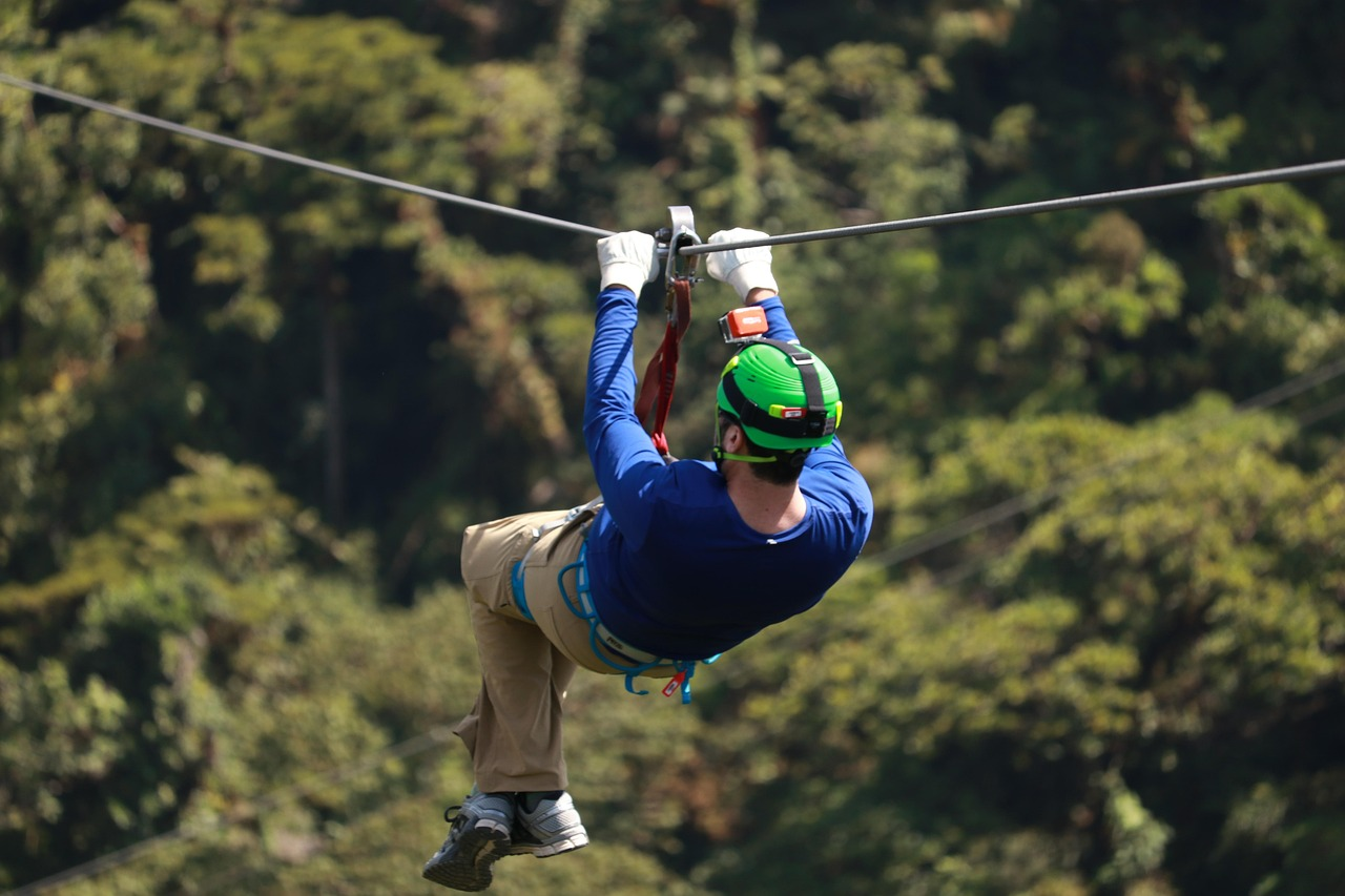 A person ziplining in aru valley wearing safety gear