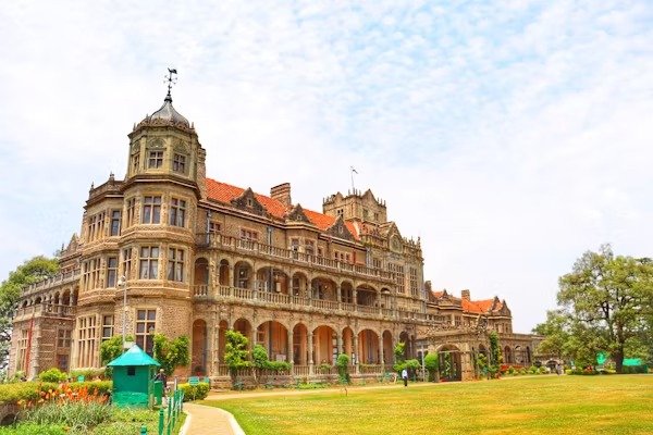 The historic Viceregal Lodge in Shimla, showcasing colonial architecture with a large lawn in front