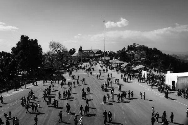 Crowd of people walking on the Ridge with buildings and trees in the background
