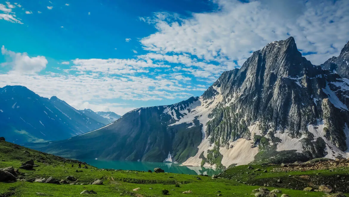 Offbeat place in Kashmir with snow-covered mountains and a lake.