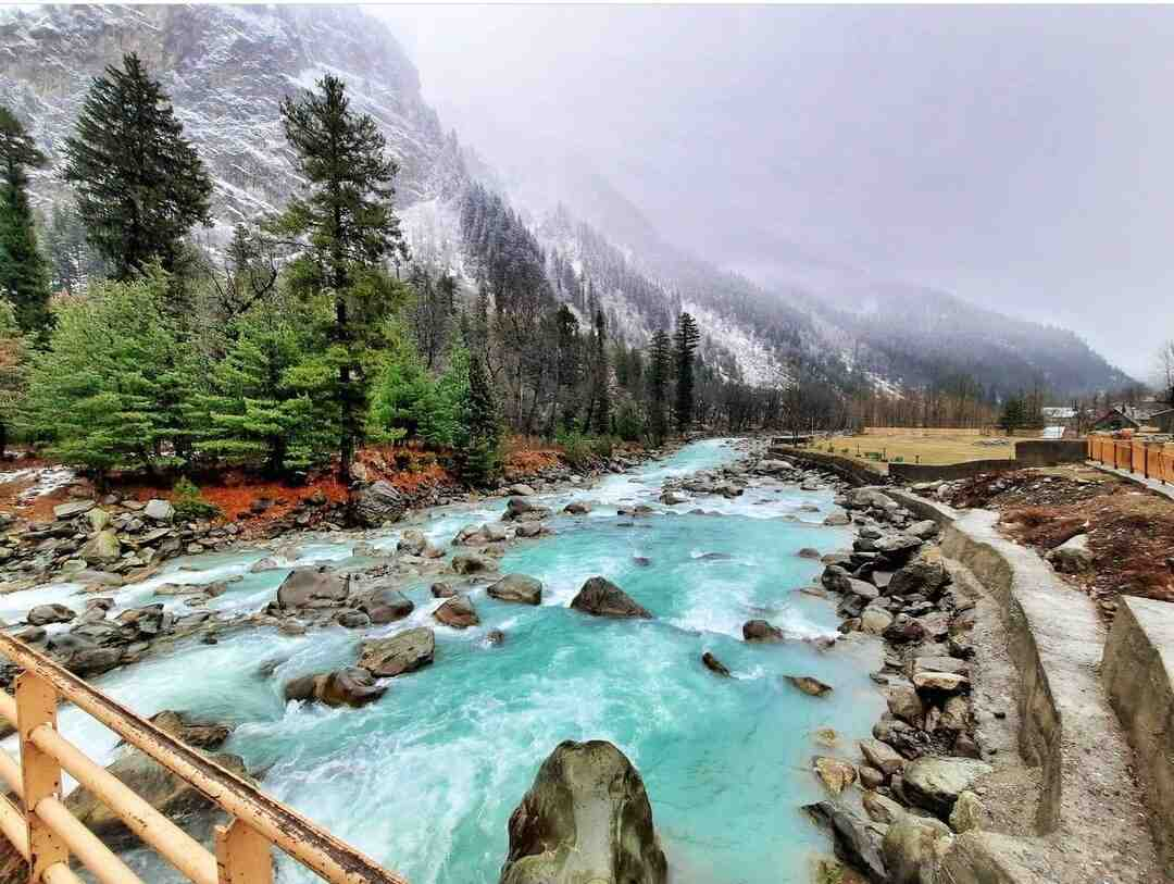 A stunning view of Sonamarg Sightseeing featuring a river flowing through a rocky landscape