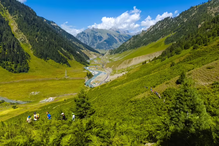 Scenic view of Kashmir valley with lush green hills and trekking trail