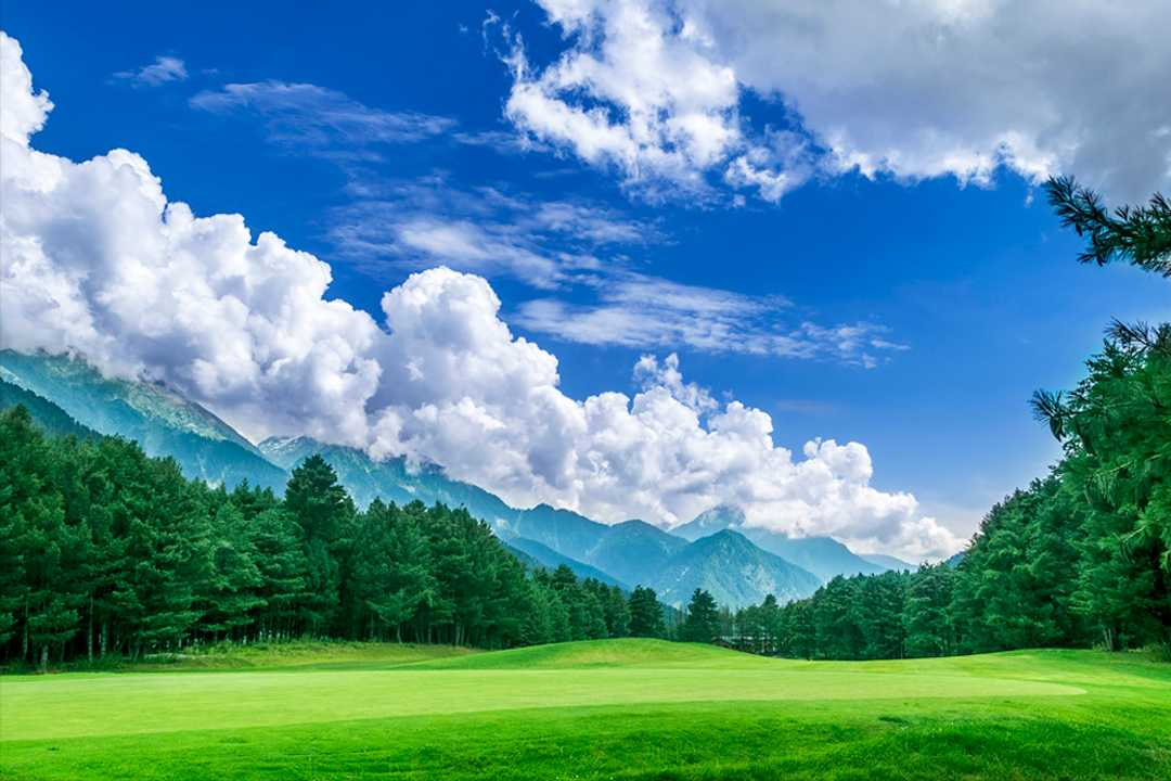 Pahalgam golf course with a mountain view and cloudy sky