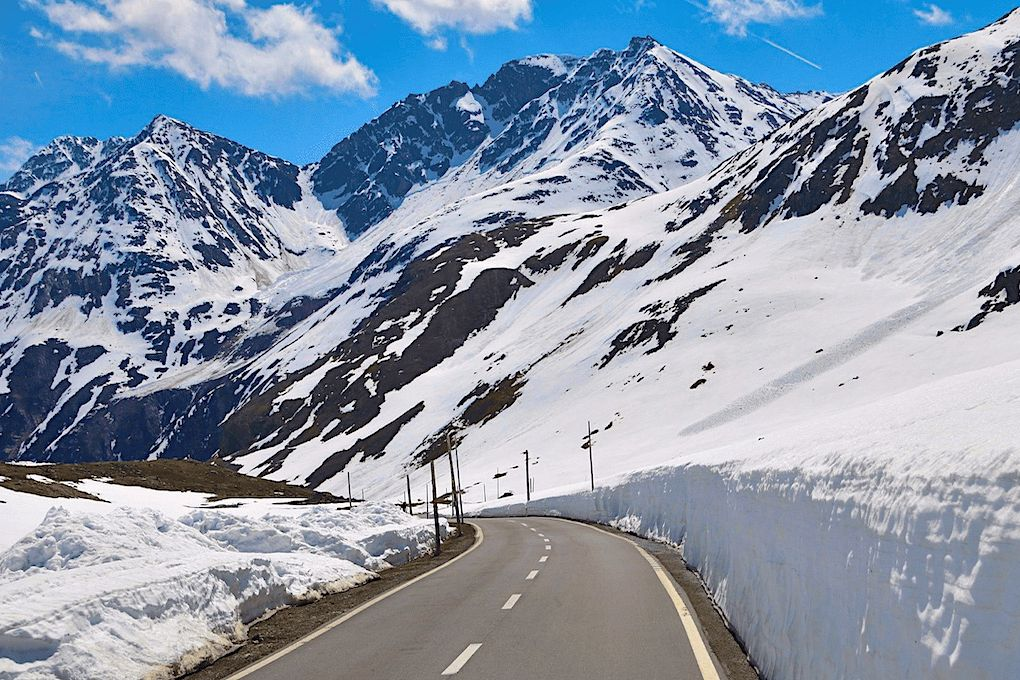 Snow-covered road winding through the mountains at Rohtang Pass