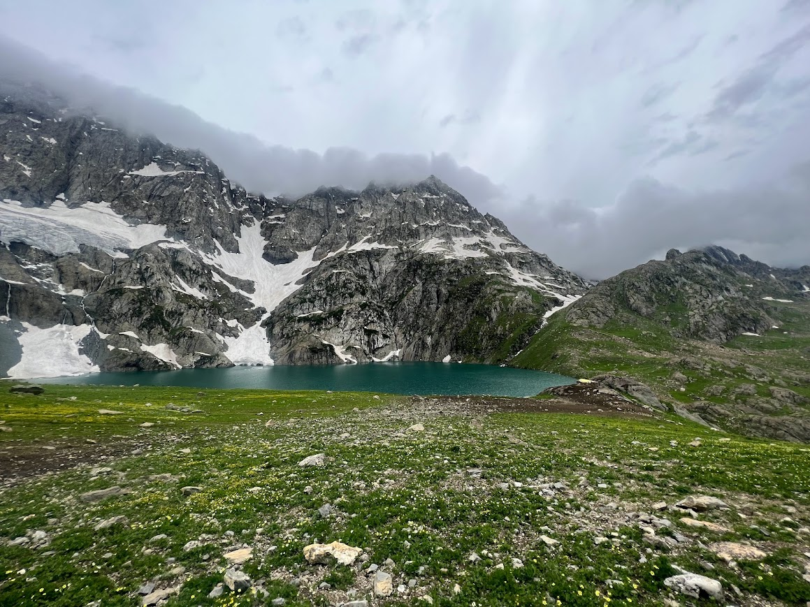 Snowy cliffs and alpine lake on Kashmir Great Lakes Trek in September