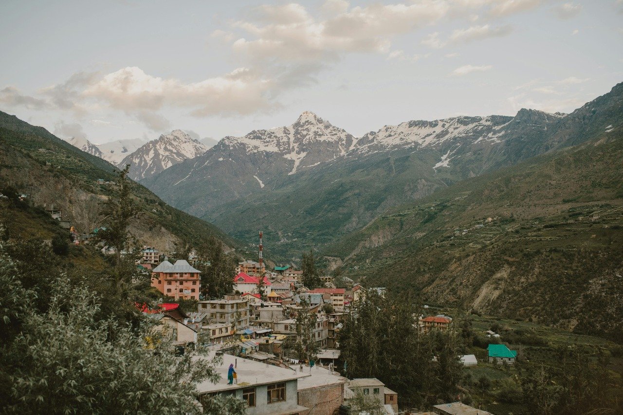 Mountain town with colorful houses and snow-capped peaks