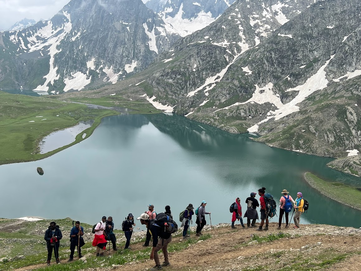 Kashmir Great Lakes Trek in June with trekkers near alpine lake